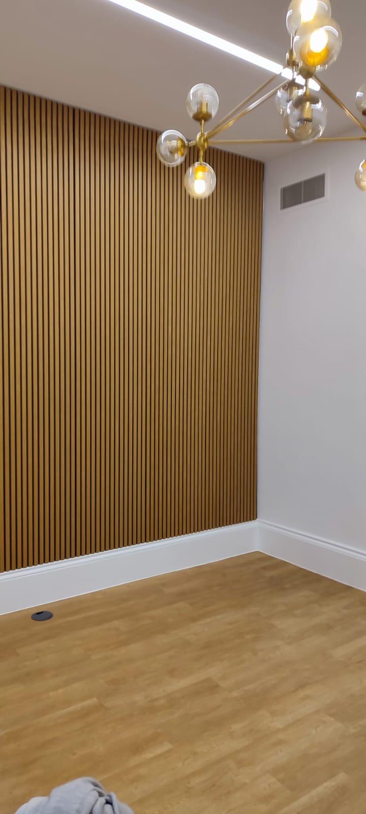 Completed panel wall with brass globe pendants